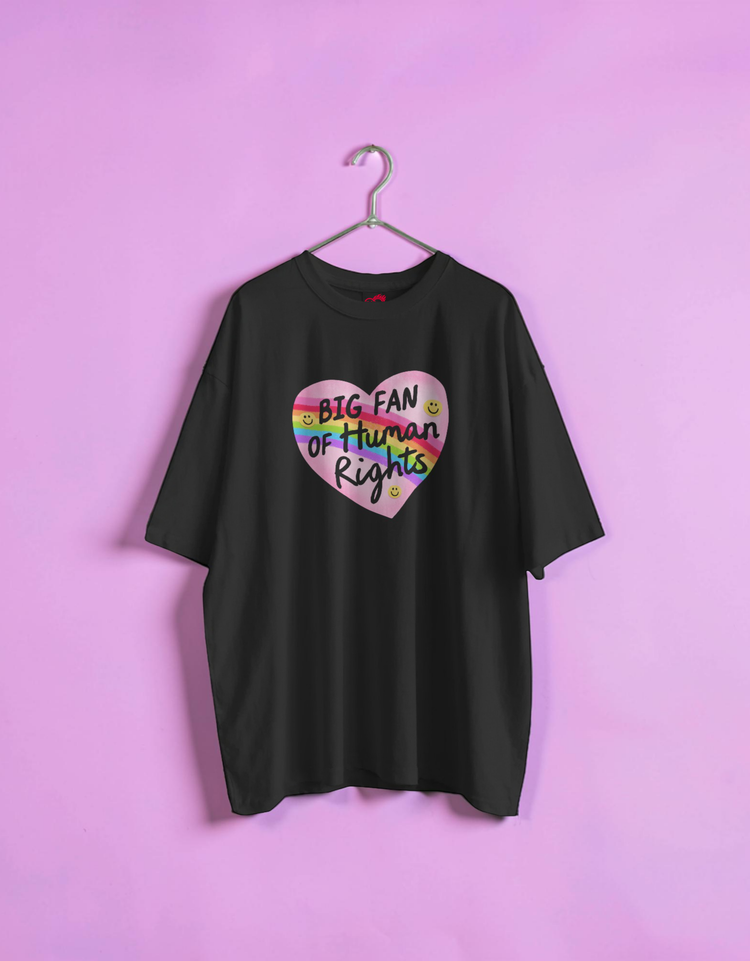 Black t-shirt with a colorful heart graphic and text on a pink background