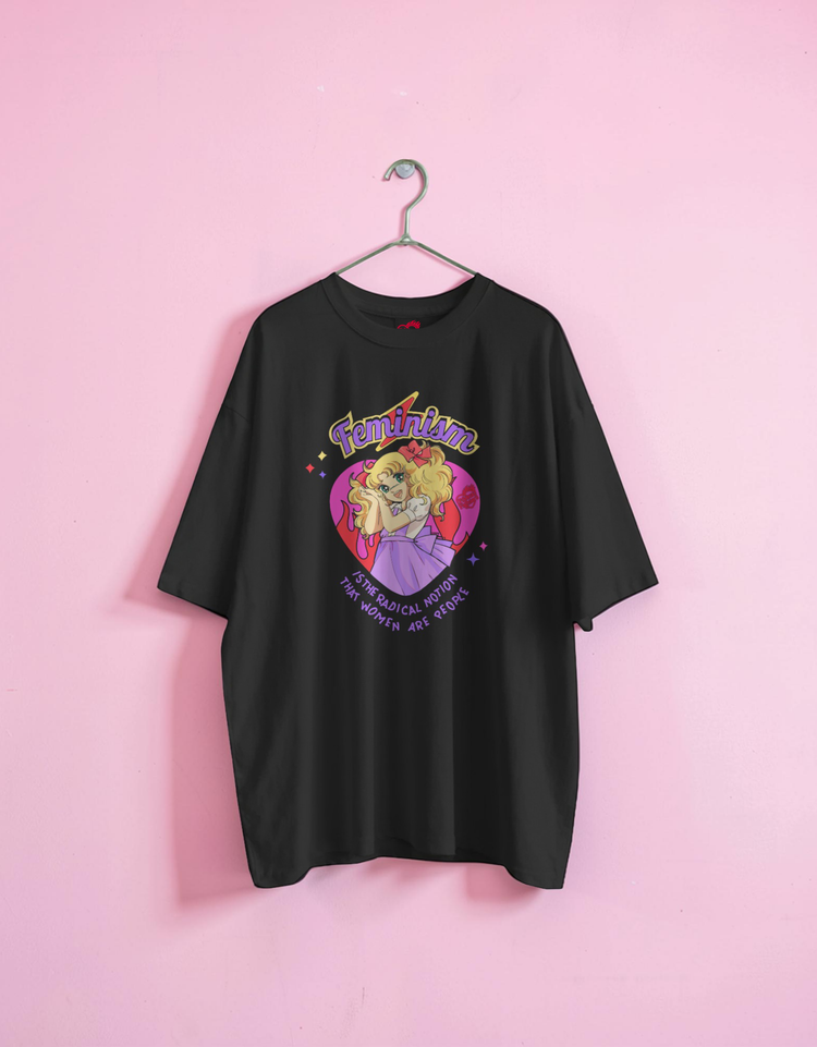 Black t-shirt with colorful graphic design on a pink background