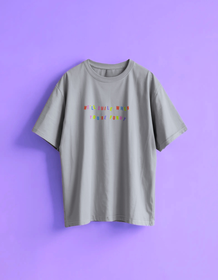 light gray t-shirt with colorful text We'll smile when you're funny