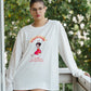 Person wearing a white sweatshirt with a graphic design outdoors