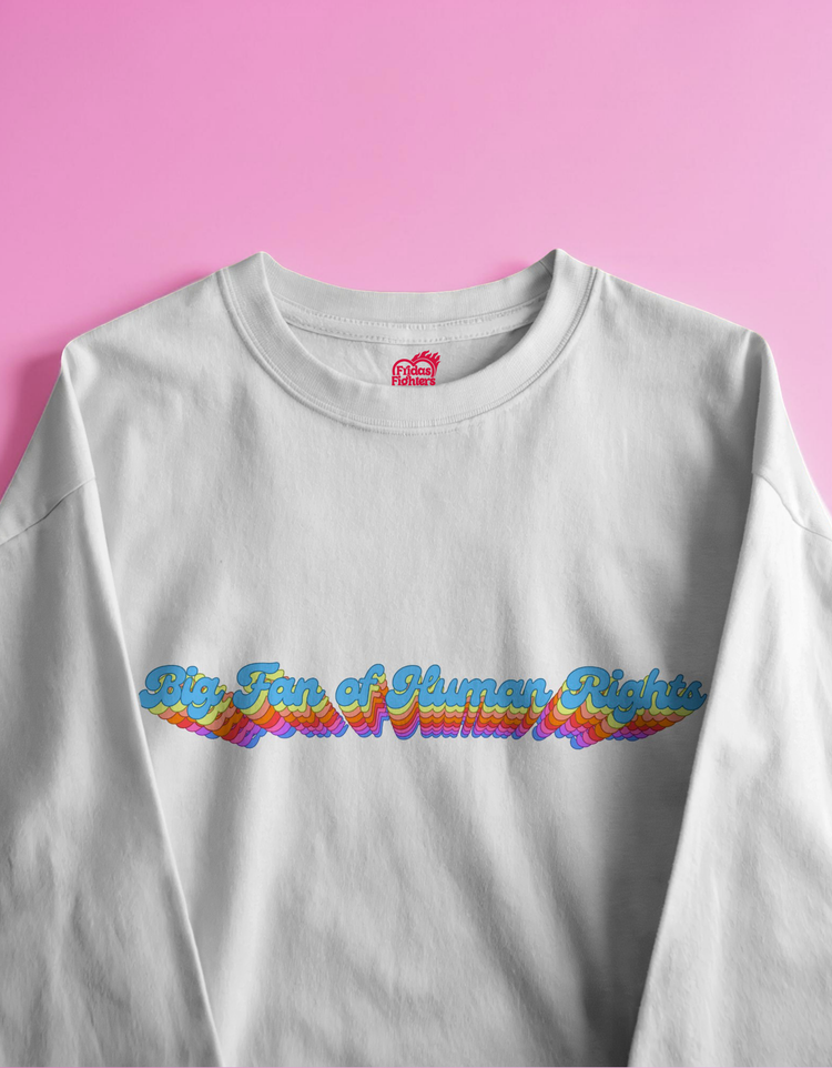 White sweatshirt with colorful text design on a pink background