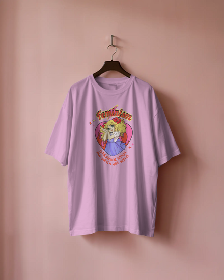 Pink t-shirt with graphic design on a hanger against a pink background