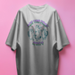 white t-shirt with cat graphic and text on a pink background