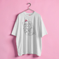 White t-shirt with graphic design on a pink background