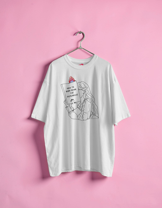 White t-shirt with graphic design on a pink background