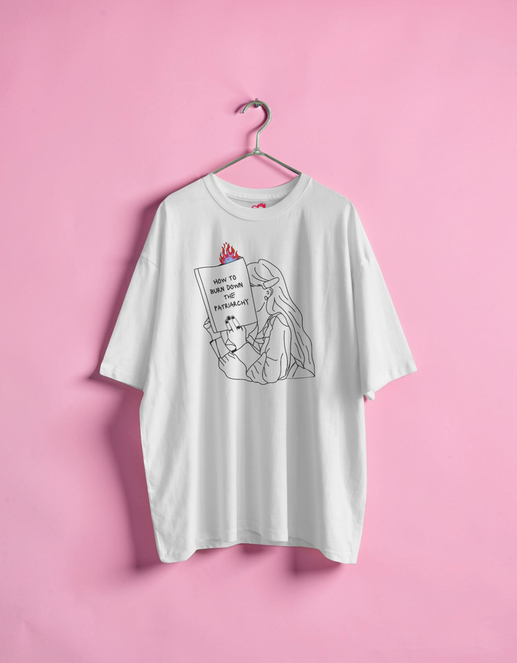 White t-shirt with graphic design on a pink background