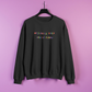 Black sweatshirt with colorful text on a pink background