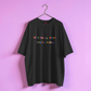 Black t-shirt with colorful text on a pink background