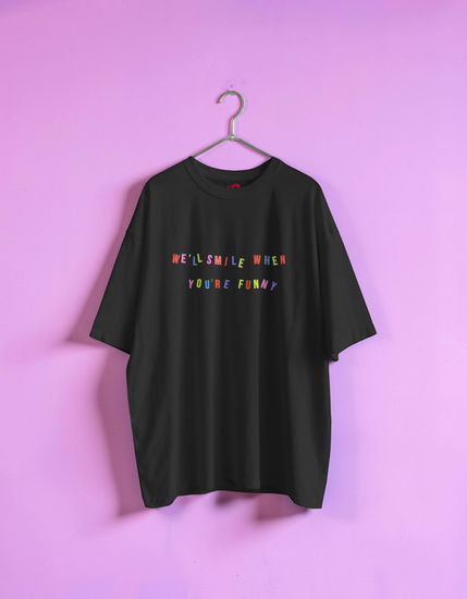 Black t-shirt with colorful text on a pink background