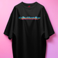 Black t-shirt with colorful graphic design on a pink background