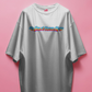 white t-shirt with colorful text design on a pink background