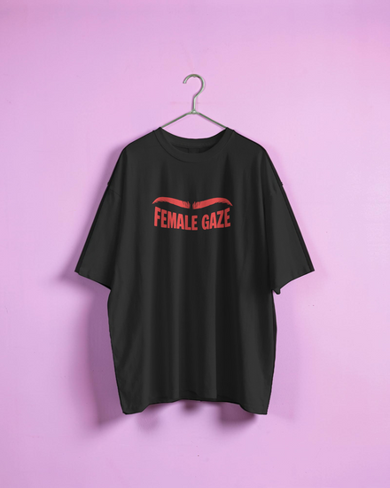 Black t-shirt with 'FEMALE GAZE' text on a pink background