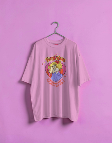 Pink t-shirt with graphic design on a hanger against a pink background
